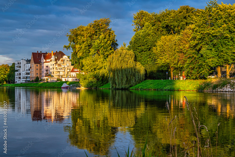 Typical architecture of houses that are reflected on the Danube illuminated by the light of the sunset. Ulm, Tübingen, Donau-Iller region, Germany, Europe