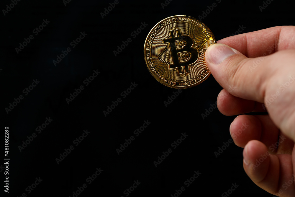 A person holds Bitcoin coins. Bitcoin purchase concept. Bitcoin and wallet. Bitcoin Conservation. Cryptocurrency. Close-up. Virtual money. Copy space A person holds Bitcoin coins. Bitcoin purchase concept. Bitcoin and wallet. Bitcoin Conservation. Cryptocurrency. Close-up. Virtual money. Copy space