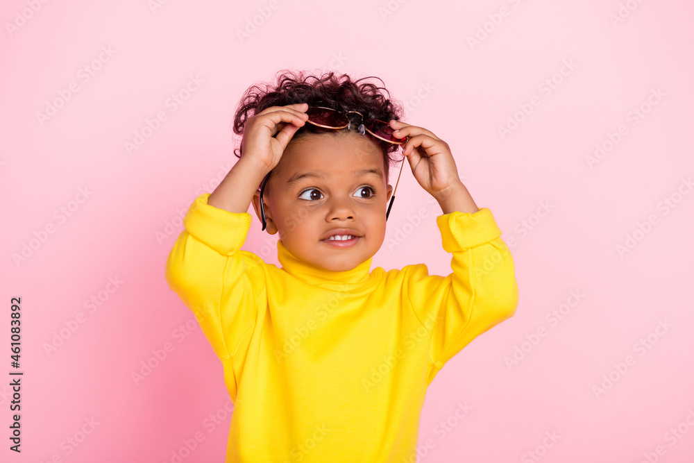 Portrait of positive dark skin people taking off sunglass look interested empty space isolated on pink color background Portrait of positive dark skin people taking off sunglass look interested empty space isolated on pink color background
