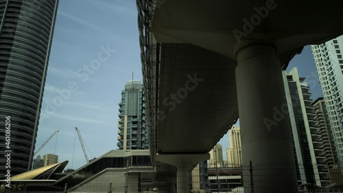 Driving under the bridge in Dubai, UAE, Abu Dabhi. Cityscape with skyscrapers.4k, footage  photo