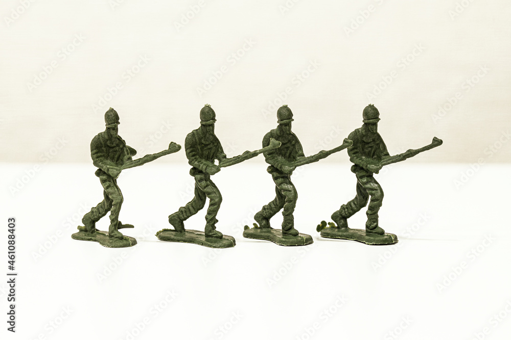 The isolated image of a group of green plastic toy soldiers