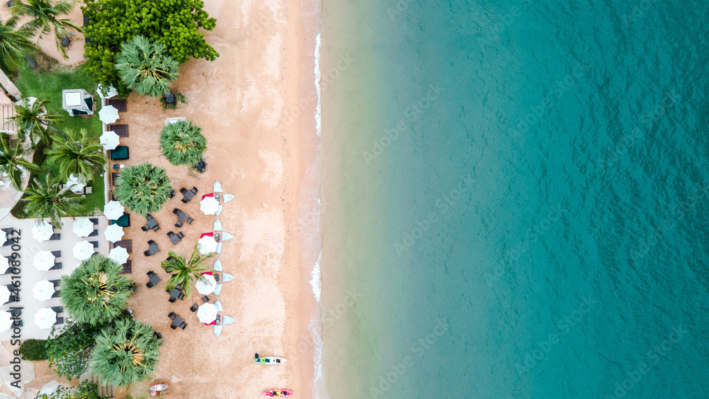 Aerial view of amazing beach with white umbrellas and turquoise sea. Umbrellas, sand and ocean.