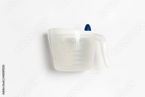 Centrifugal dryer for salad on white background. Mechanical dryer for greens. Plastic Vegetable Spinner.High-resolution photo. photo