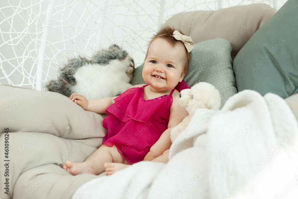 Lovely smiling little girl lies on the bed with plush toys. Childhood Lovely smiling little girl lies on the bed with plush toys. Childhood