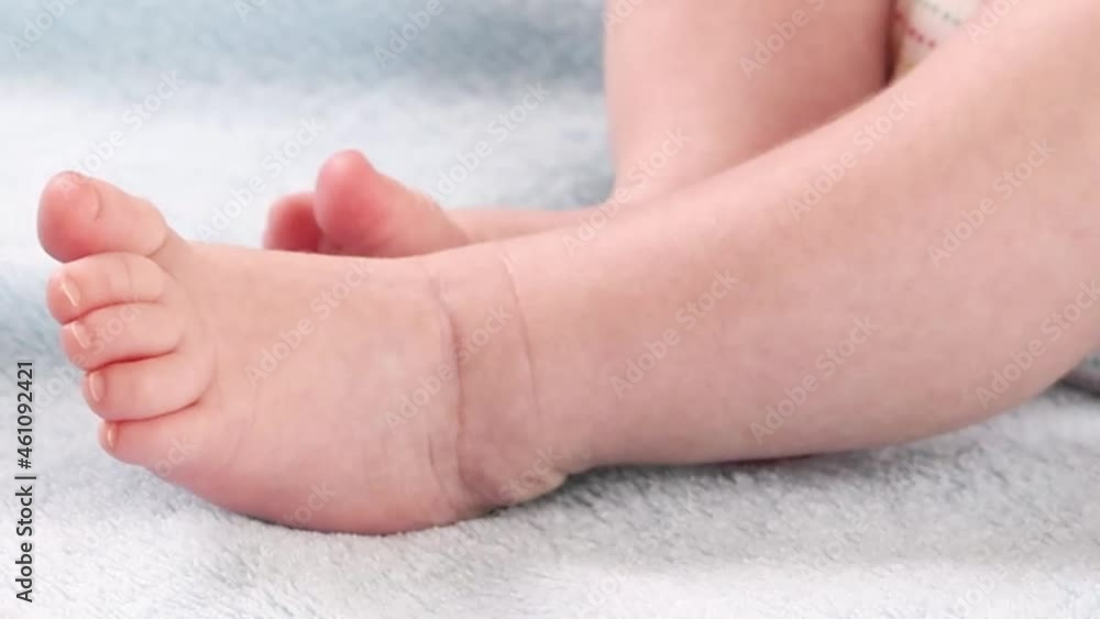 Close-up of moving legs and feet of a small baby Close-up of moving legs and feet of a small baby