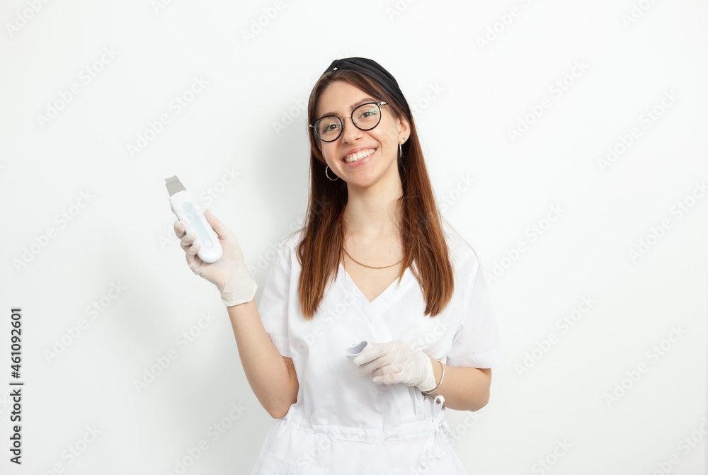 Portrait of young attractive doctor beautician with ultrasonic cosmetic tool Portrait of young attractive doctor beautician with ultrasonic cosmetic tool