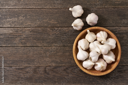 fresh garlic on a rustic wooden table, copy space for text. Top view.