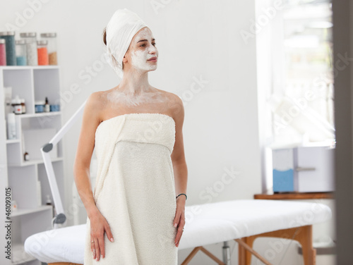 Beautiful woman with facial mask in beauty salon. Skin care concept