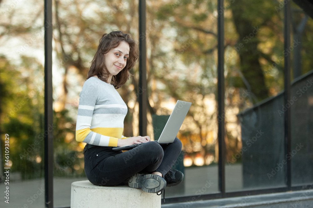 Young woman with laptop in the city Young woman with laptop in the city