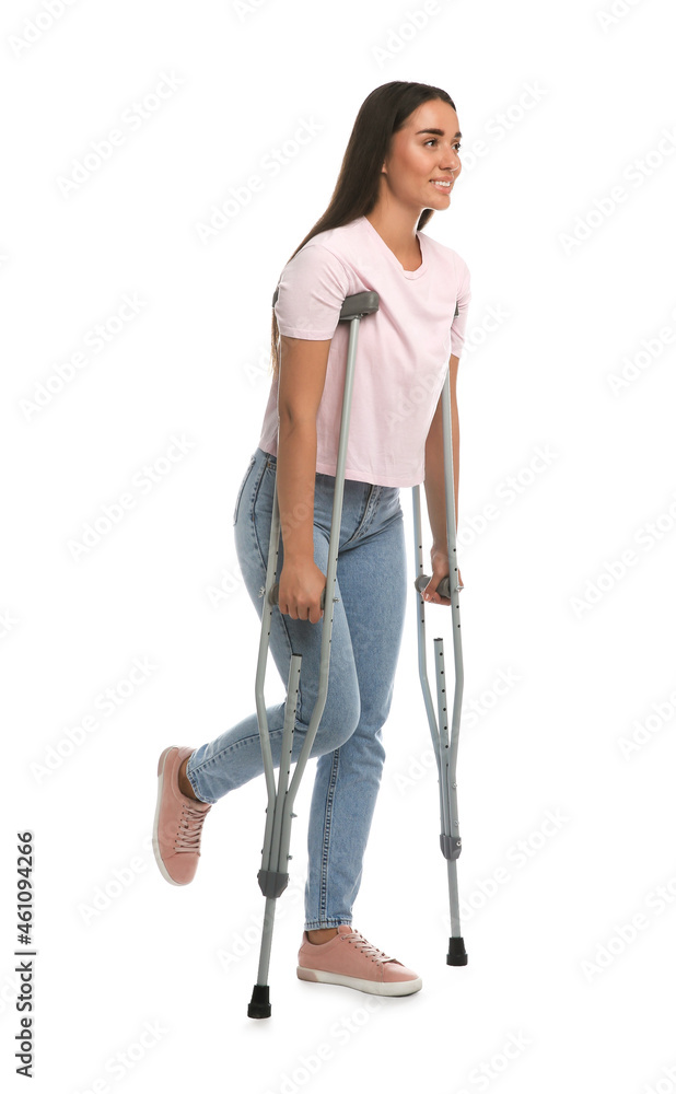 Young woman with axillary crutches on white background Young woman with axillary crutches on white background