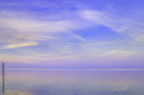 Beautiful sunset on sea  pastel colors and reflections on water  calm nature landscape with colorful clouds