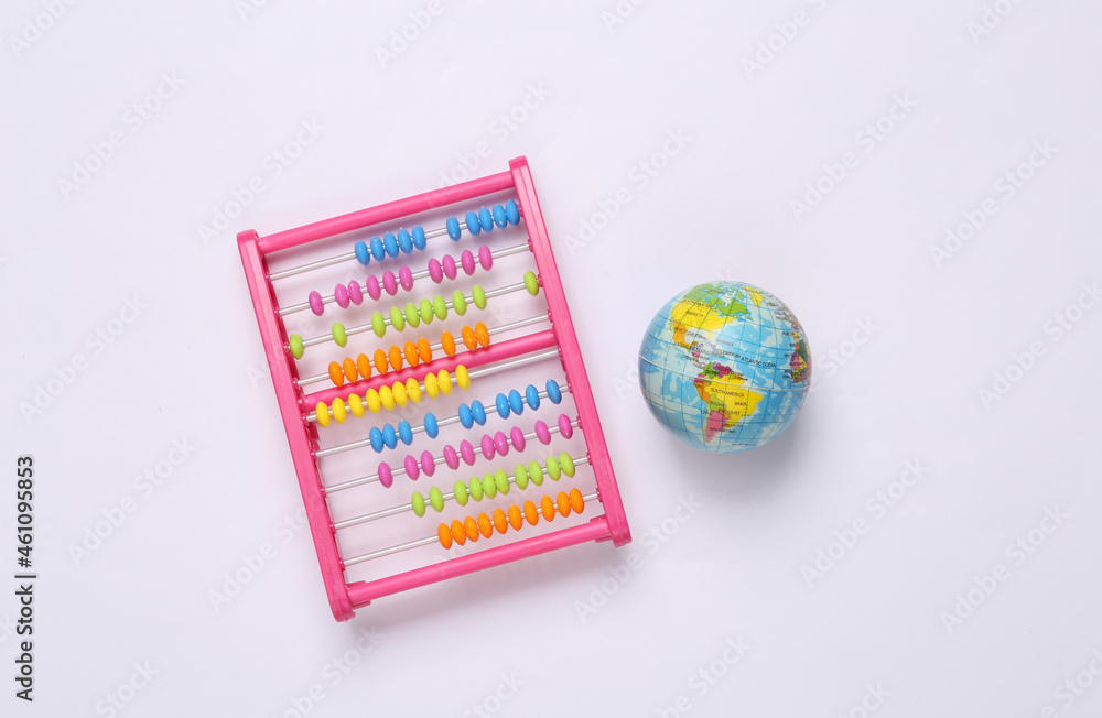 Globe with toy abacus on white background. Education concept Globe with toy abacus on white background. Education concept