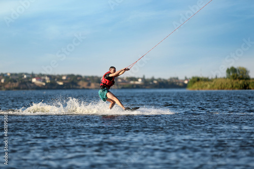 Man wakeboarding on river. Extreme water sport © New Africa