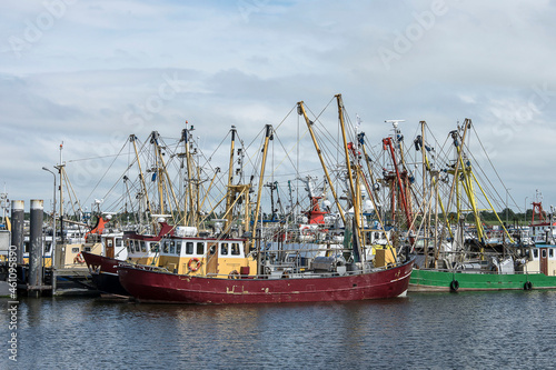 fishing boats with nets laying in the harbor of Lauwersoog on a sunny sunday