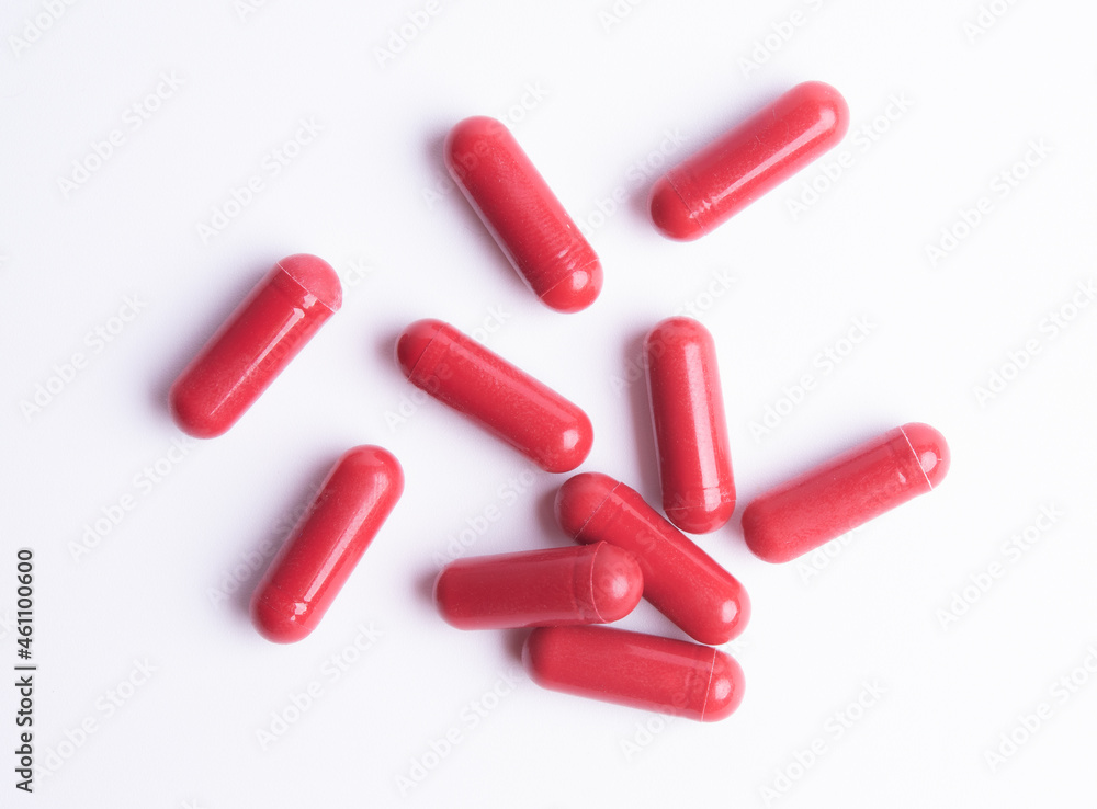 Red pills in capsules isolate on white background Red pills in capsules isolate on white background
