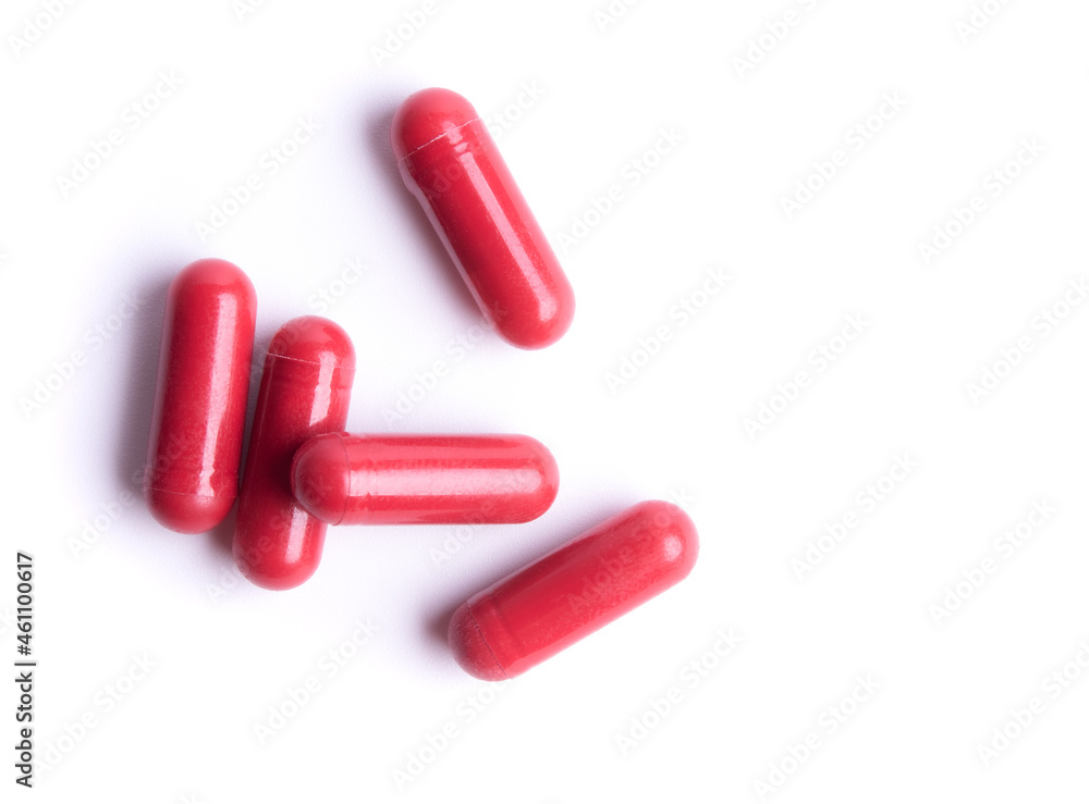 Red pills in capsules isolate on white background Red pills in capsules isolate on white background
