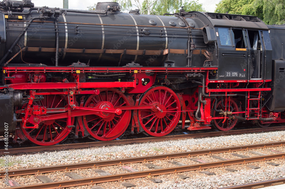 Old historic steam black locomotive with red wheels at station Dieren in the Netherlands