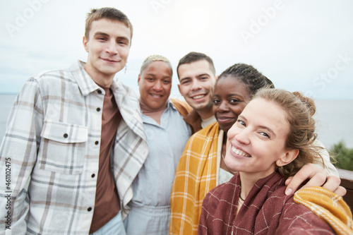 POV shot of diverse group of young friends taking selfie at viewpoint during hike, copy space
