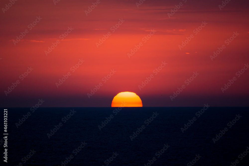 Red disk of the sun. Sea sunset.