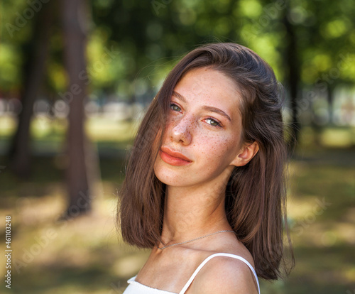 Canvas Print Young beautiful brown-haired girl with freckles on her face
