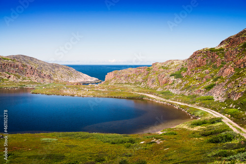 Mountain lake in the North. Moss-covered hills, and stunted vegetation.