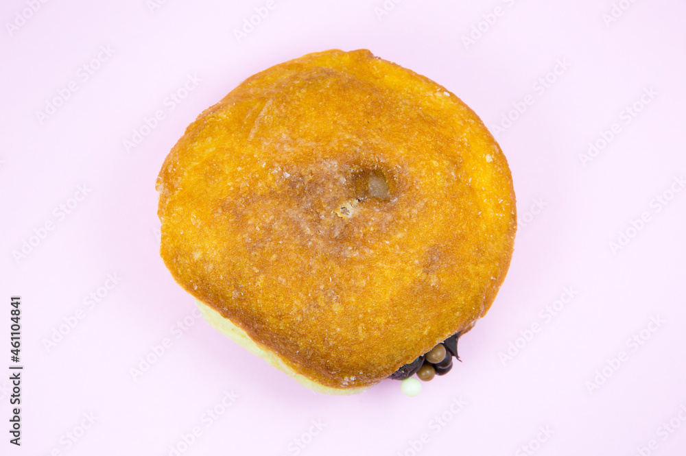 Donut with chocolate. Delicious sweets temptation and desserts on a pink background. Minimalism, original and creative image. Beautiful food wallpaper. Donut with chocolate. Delicious sweets temptation and desserts on a pink background. Minimalism, original and creative image. Beautiful food wallpaper.