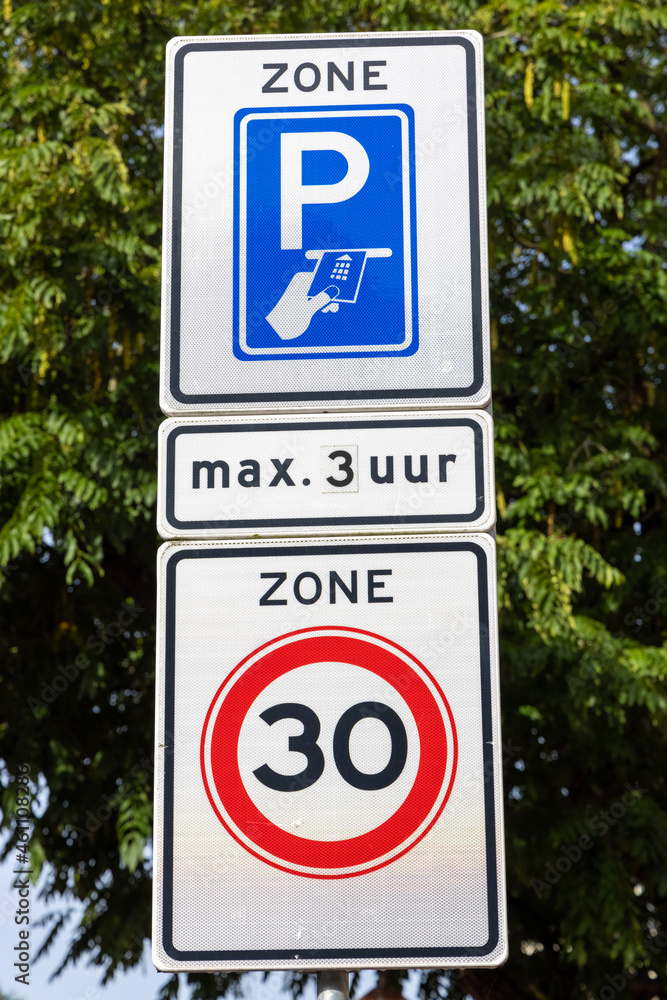 Road signs. Metered parking for three hours maximum. Thirty kilometer zone. Road signs. Metered parking for three hours maximum. Thirty kilometer zone.