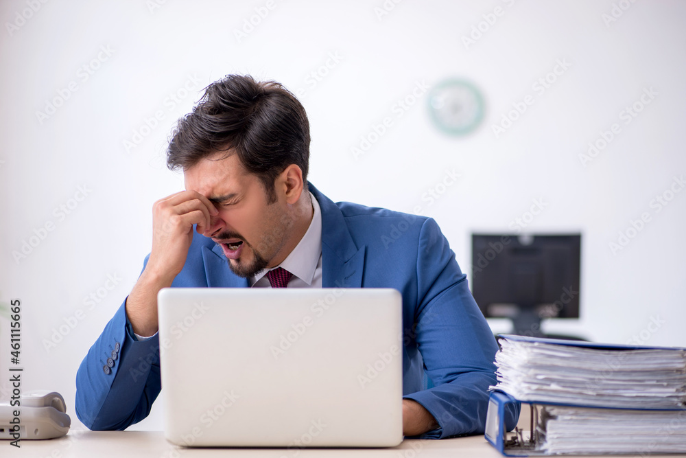 Young male employee working in the office Young male employee working in the office