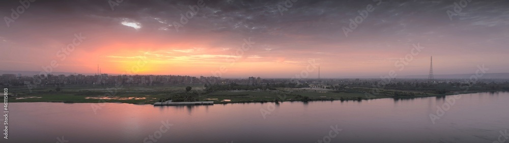 Panorama sunset scene from Sohag city in south Egypt showing Qaraman island which overlooks the Nile river