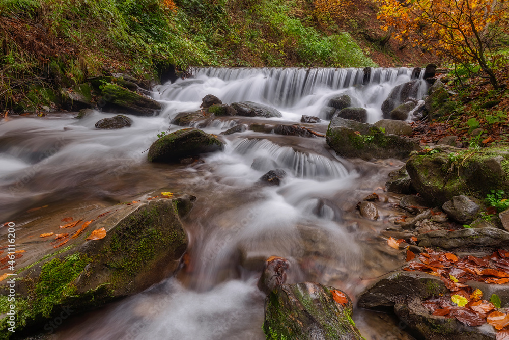 Beautiful waterfall in the forest, fall season outdoor background Beautiful waterfall in the forest, fall season outdoor background