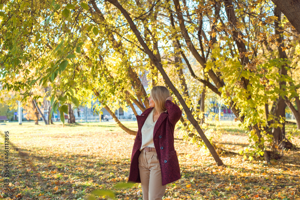 woman standing in autumn park woman standing in autumn park