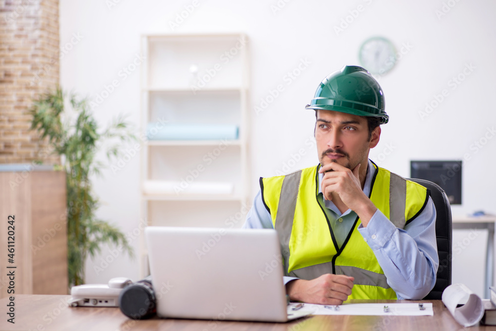 Young male architect working in the office Young male architect working in the office