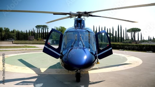 Modern blue Helicopter on helipad lot is waiting for its passengers