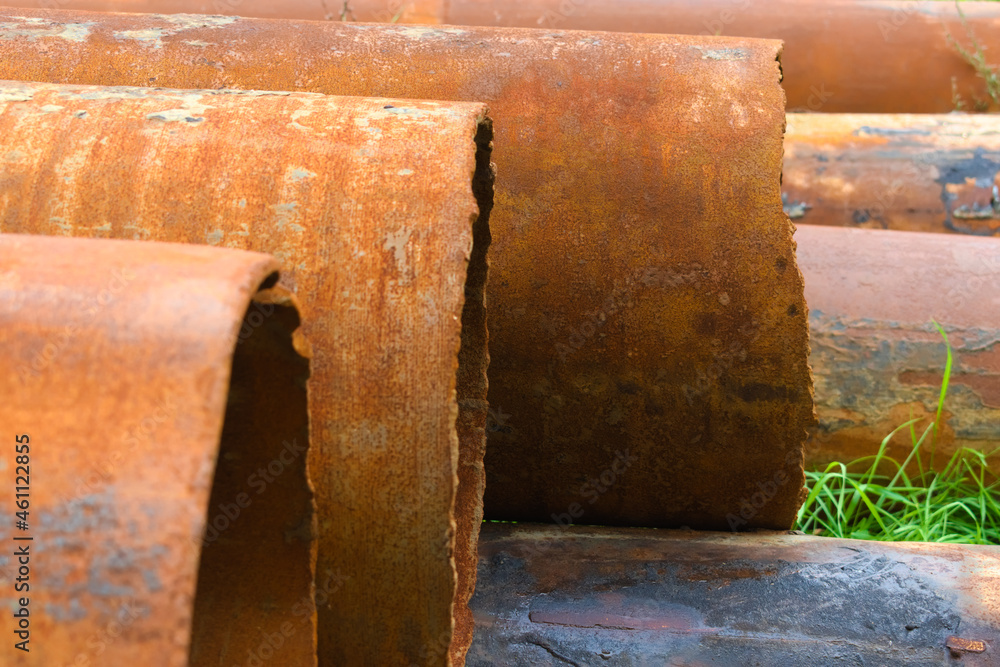 Stacked rusty metal pipelines in construction site