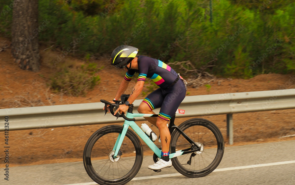 Naklejka premium YOUNG TRIATHLETE RIDEING A BIKE