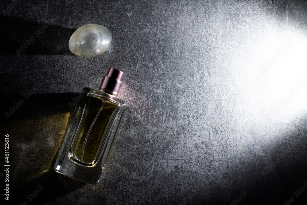 Beautiful composition with bottle of perfume on dark background, flat lay Beautiful composition with bottle of perfume on dark background, flat lay