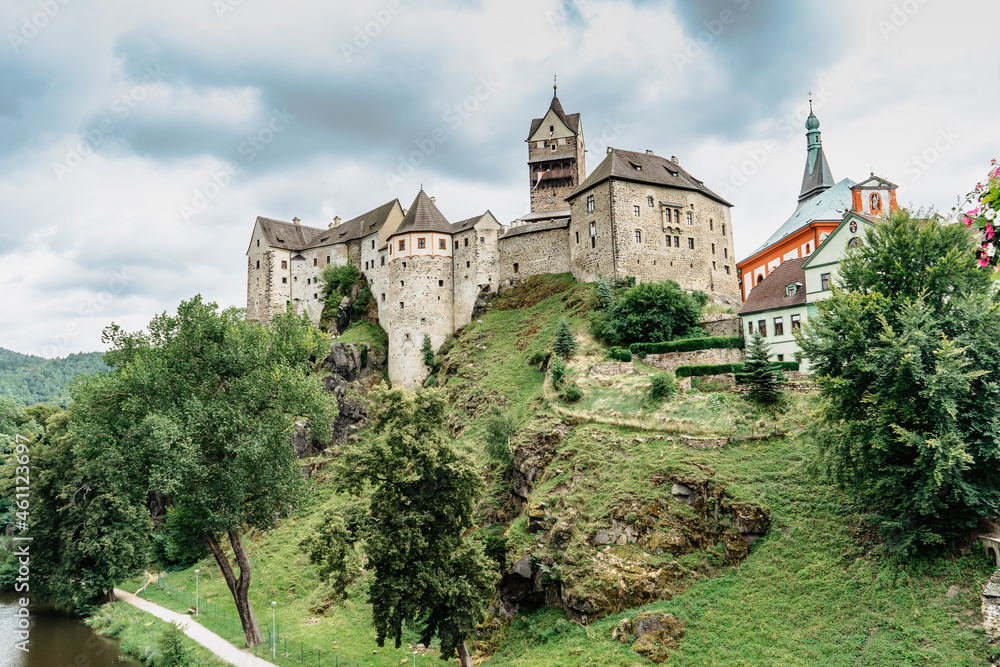 Panoramic view of famous medieval town of Loket,Elbogen, with colorful houses and stone castle above river,Czech Republic.Historical city centre is national monument.Travel architecture background. Panoramic view of famous medieval town of Loket,Elbogen, with colorful houses and stone castle above river,Czech Republic.Historical city centre is national monument.Travel architecture background.