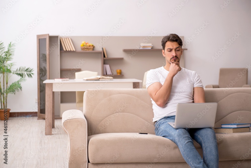 Young male student studying at home during pandemic Young male student studying at home during pandemic
