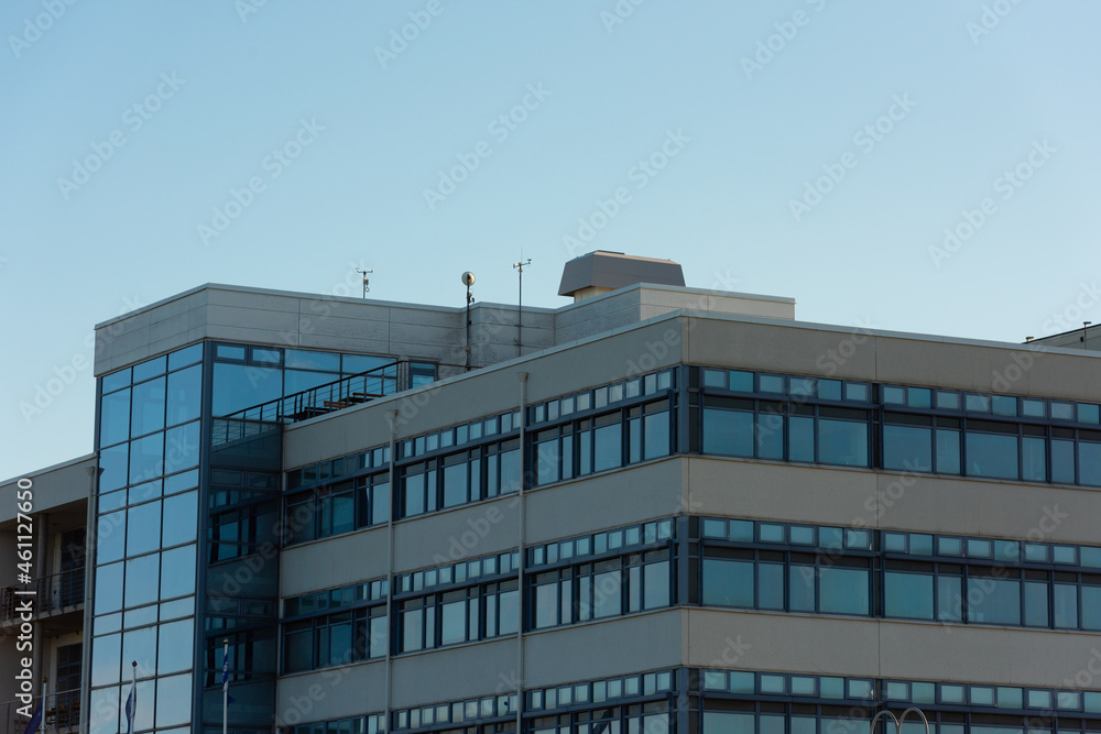 Top floors of a concrete and glass office complex.