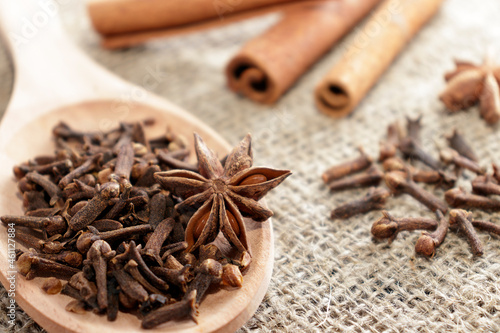 christmas mulled wine, a set of spices for mulled wine. Traditional Christmas spices - Star anise with cinnamon and cloves on a dark rustic wooden background