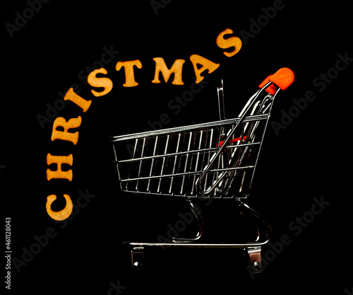 Christmas shopping concept. Shopping trolley, isolated on black.