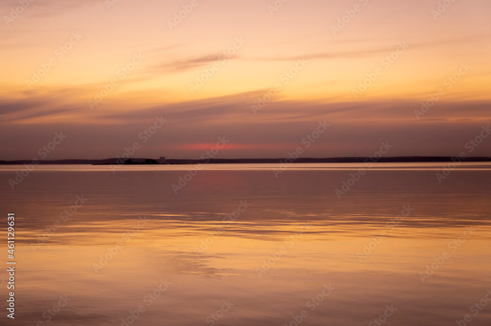 Beautiful sunset on the lake on an autumn evening.