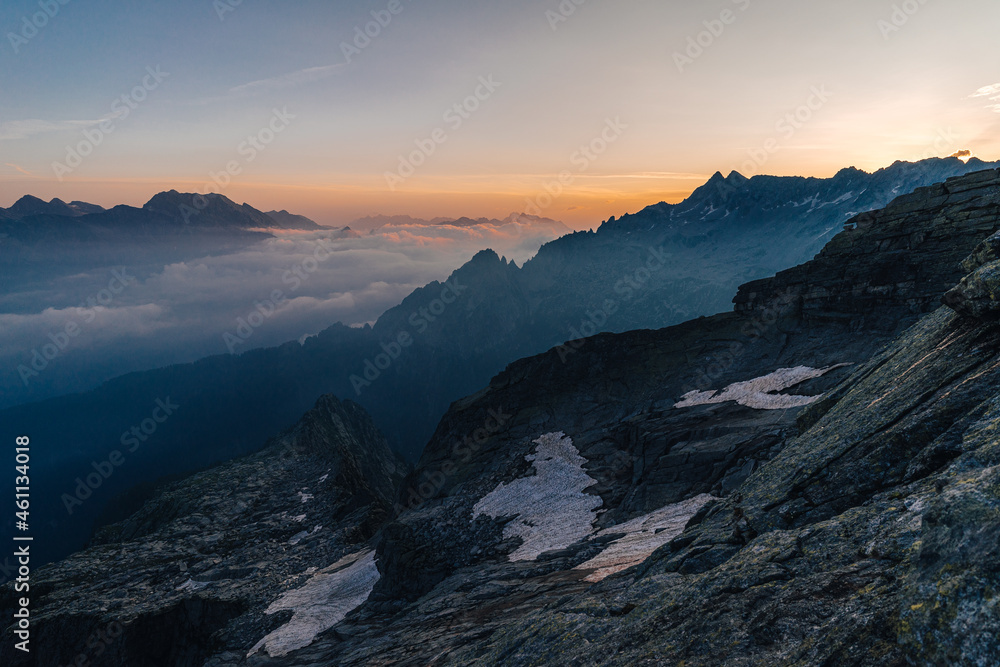 Dusk or dawn light above alpine mountain landscape of Bregaglia (Bergell), Switzerland. Beutiful sunset photograph of mountains.