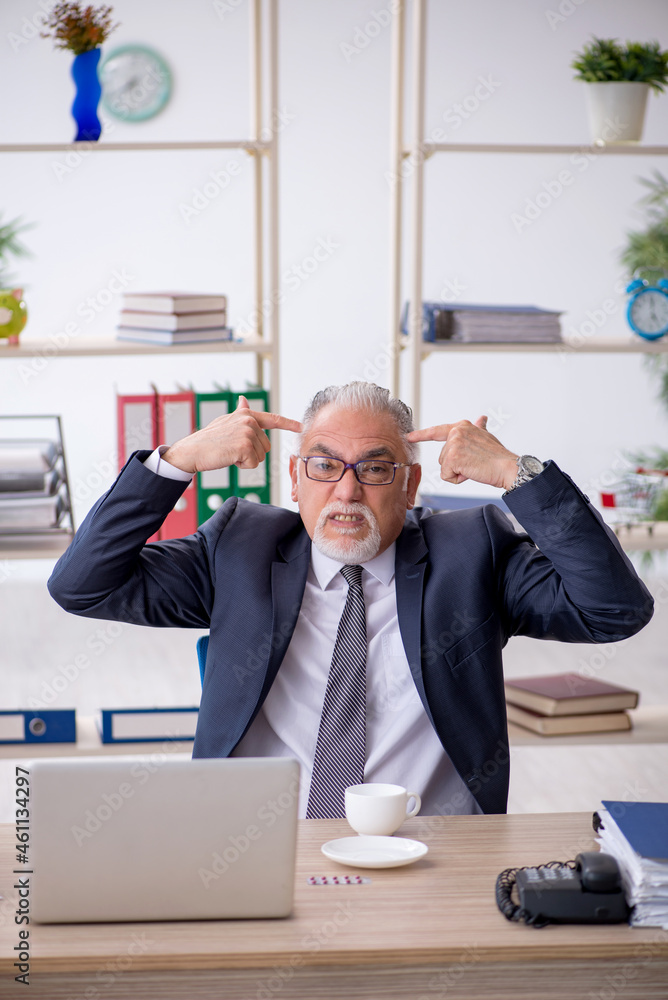 Old male employee feeling bad at workplace Old male employee feeling bad at workplace