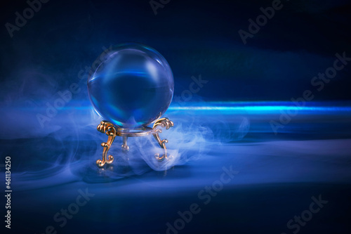 Tablou pe pânză Crystal ball in a dark blue smoky background