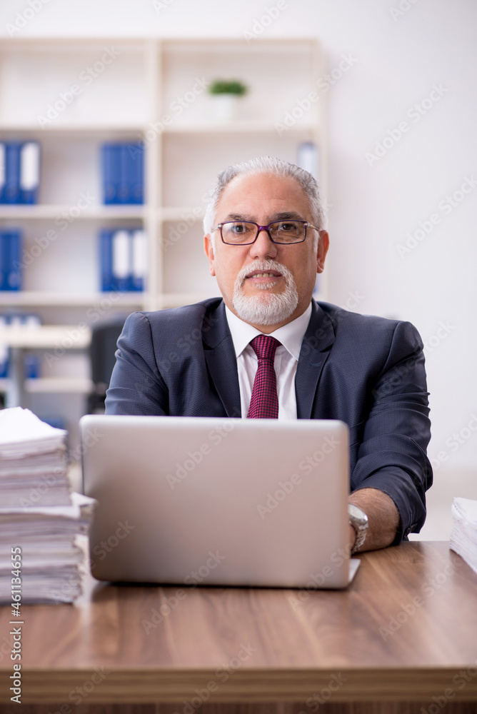Old male employee and too much work in the office Old male employee and too much work in the office