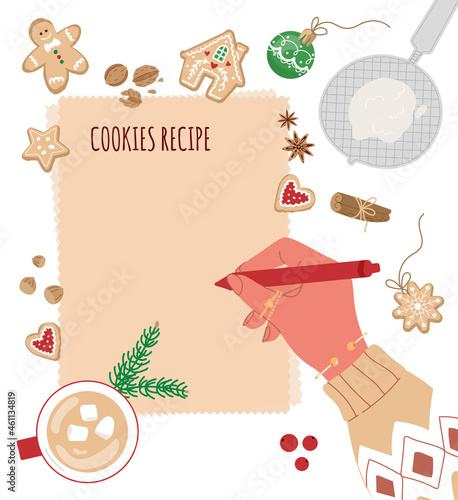 Hand in sweater with a pen write on a blank cooking page. Preparing for baking.Top view.