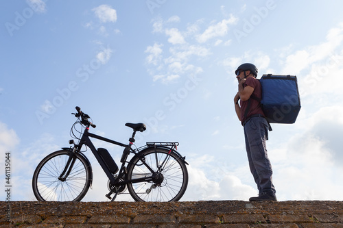 electric bicycle delivery person prepared for work