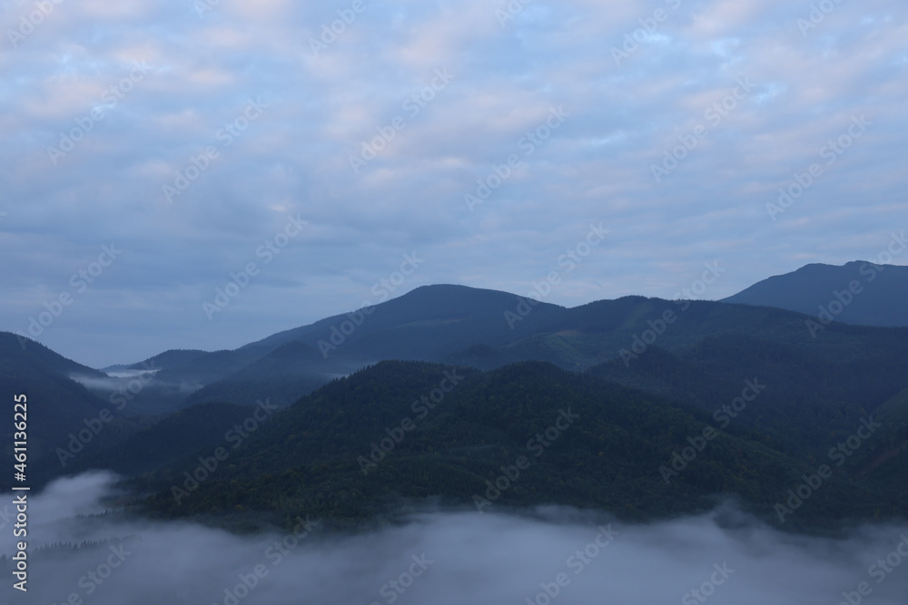Picturesque view of mountains covered with fog Picturesque view of mountains covered with fog