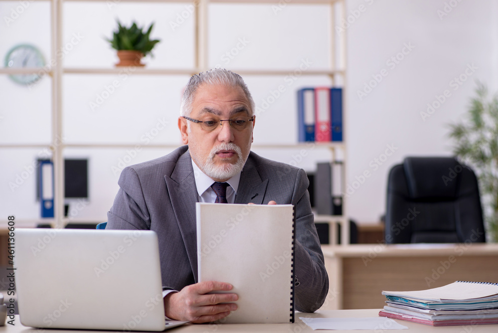 Old male employee and too much work in the office Old male employee and too much work in the office